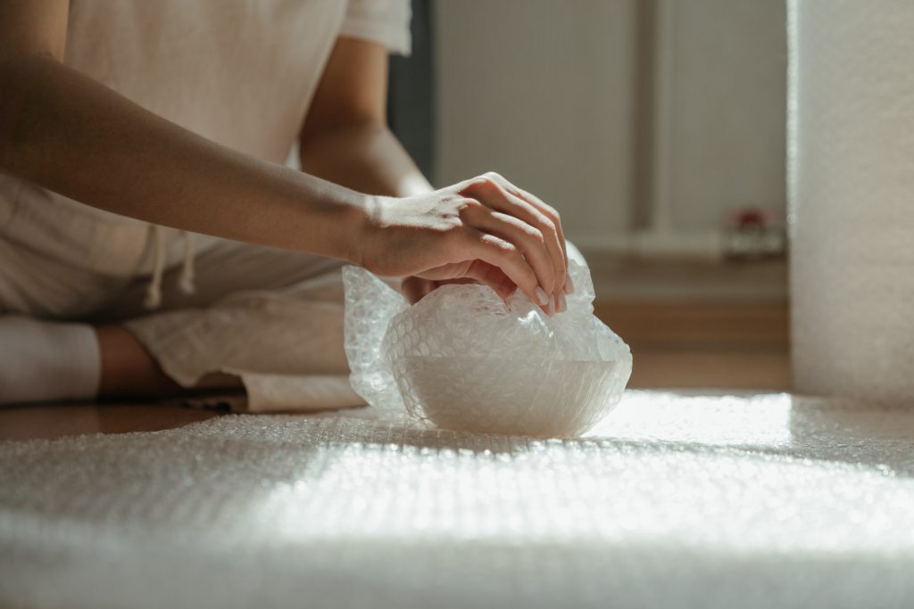 Person holding white plastic bag